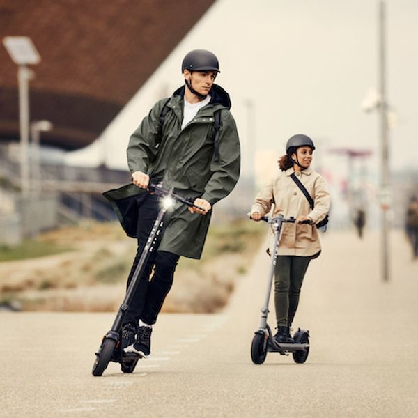 Pure Air e scooters being ridden by a man and woman